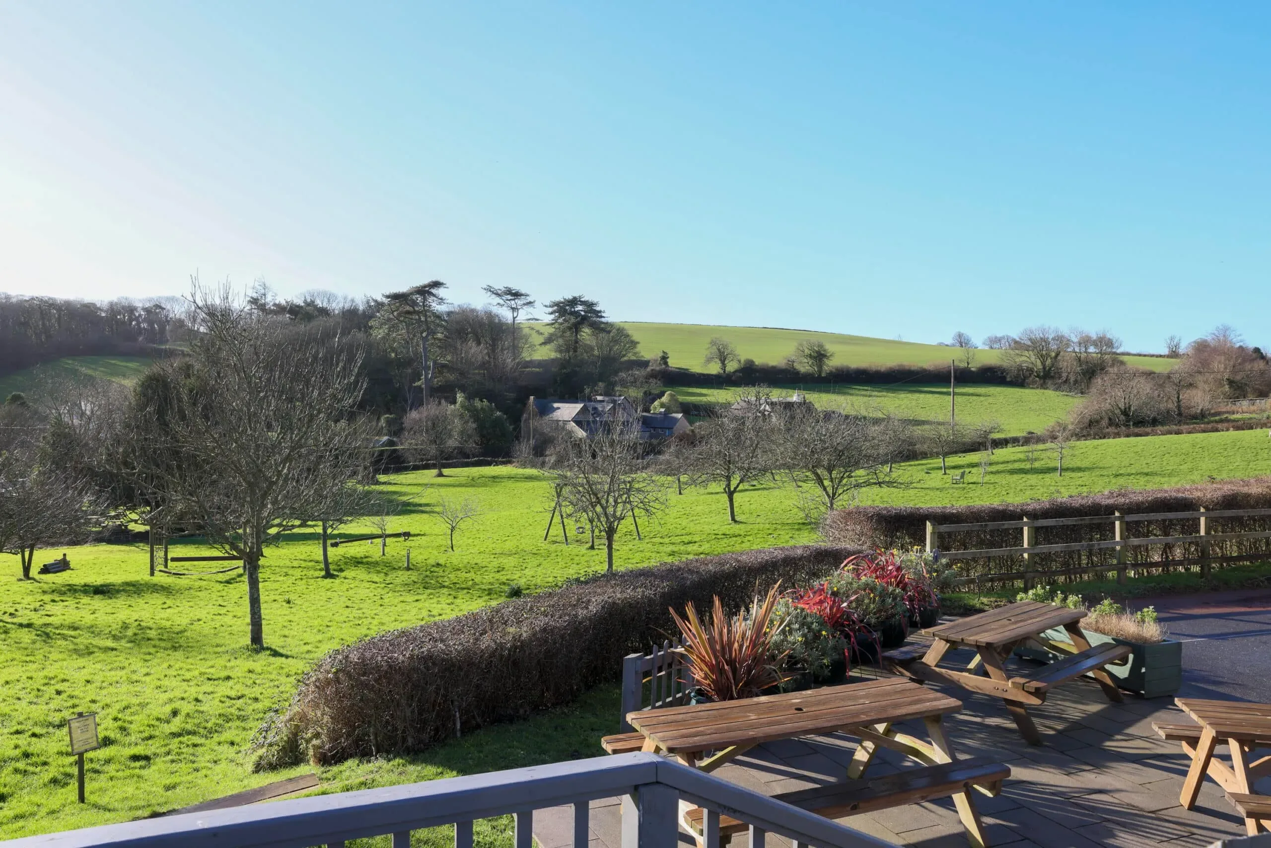 Pub garden terrace looking out over fields and orchard