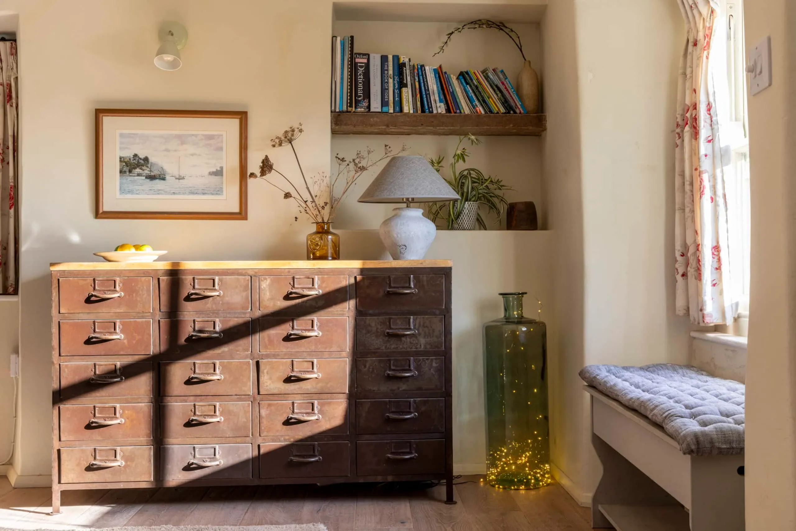 Chest of drawers, bookshelves and window seat in the lounge